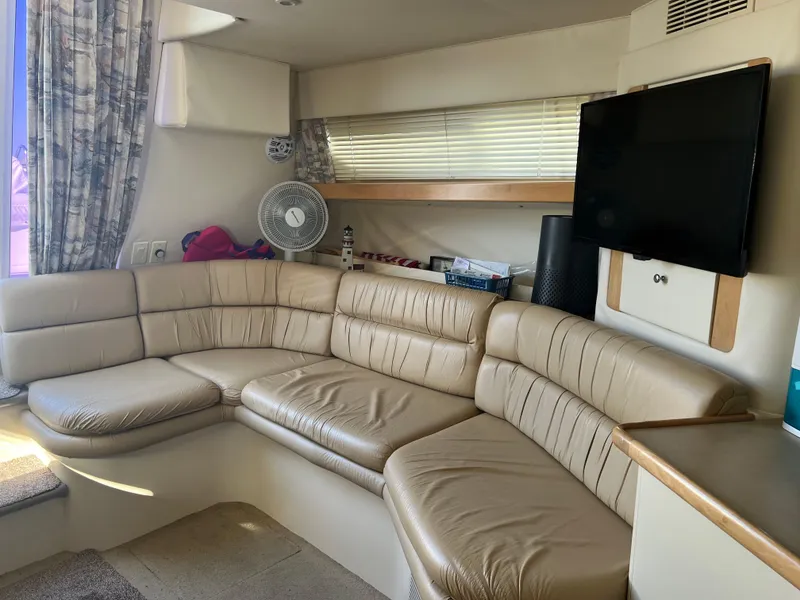 Slide: The Image of 1997 Carver 380 Santego SE interior with beige leather seating and mounted TV. - 20