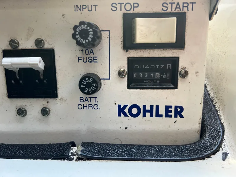 Slide: The Image of Kohler generator control panel with 10A fuse, start/stop buttons, and hour meter on Carver 380 Santego SE. - 27