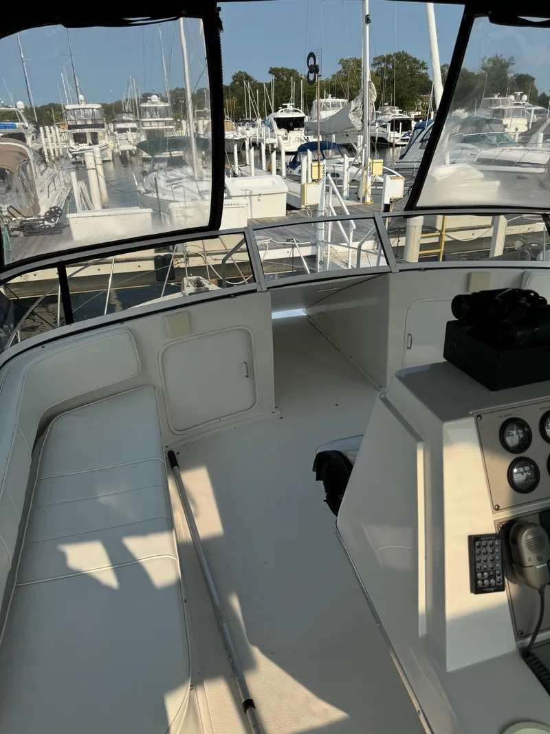 Slide: The Image of 1997 Carver 380 Santego SE yacht interior at marina, featuring helm and seating area. - 42
