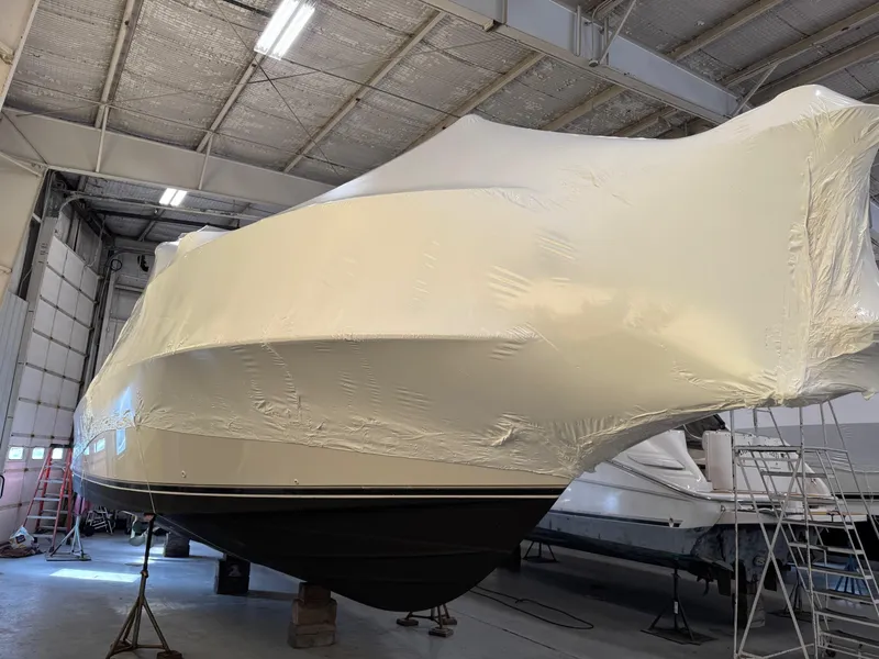 Slide: The Image of 1997 Carver 380 Santego SE yacht covered in protective wrap inside a storage facility. - 49