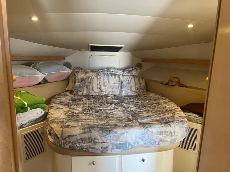 Slide: The Image of Cozy cabin interior of 1997 Carver 380 Santego SE with bed and storage. - 19