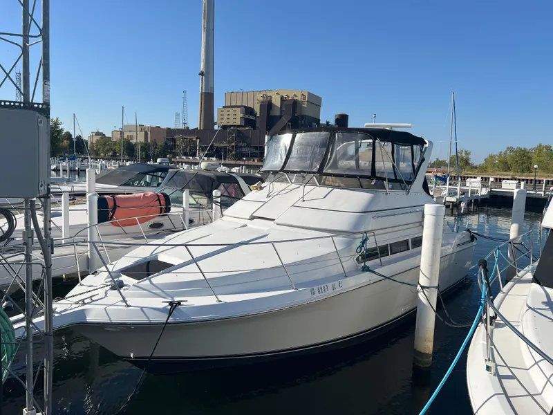 Slide: The Image of 1997 Carver 380 Santego SE yacht docked in marina under clear blue sky. - 2