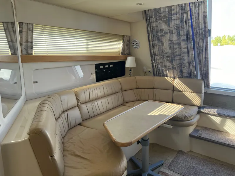 Slide: The Image of Interior of 1997 Carver 380 Santego SE yacht with beige seating and table. - 21