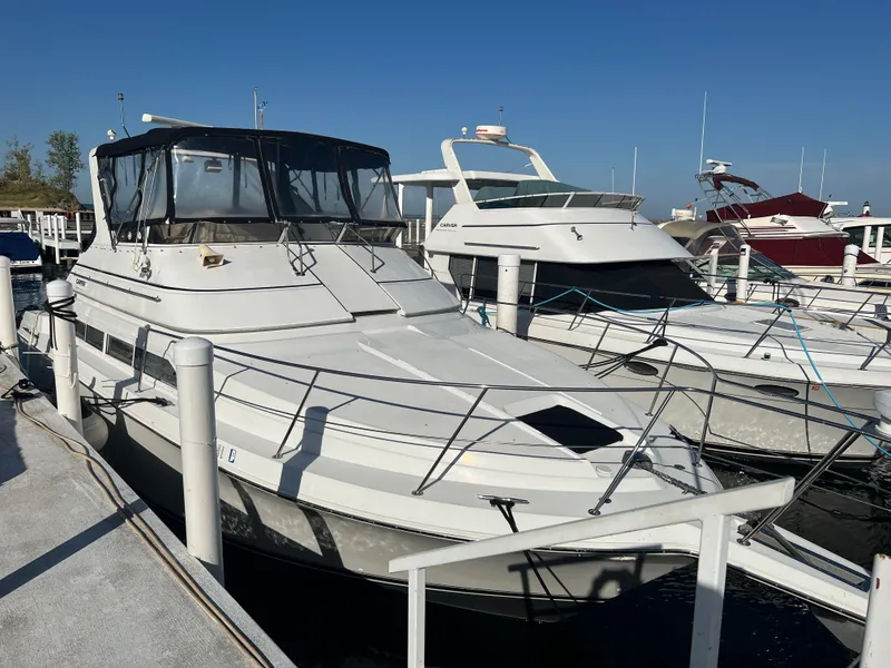 Slide: The Image of 1997 Carver 380 Santego SE yacht docked at marina under clear blue sky. - 3
