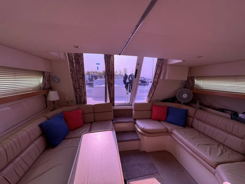 Slide: The Image of Interior of 1997 Carver 380 Santego SE yacht with beige seating and colorful cushions. - 40