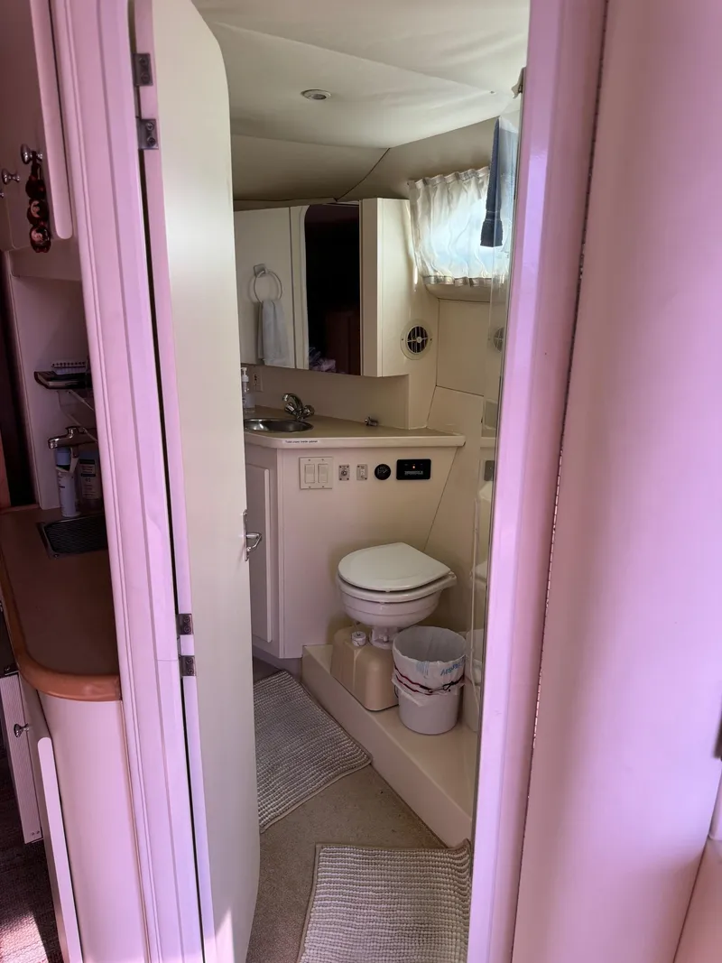 Slide: The Image of 1997 Carver 380 Santego SE yacht bathroom interior with sink and toilet. - 45