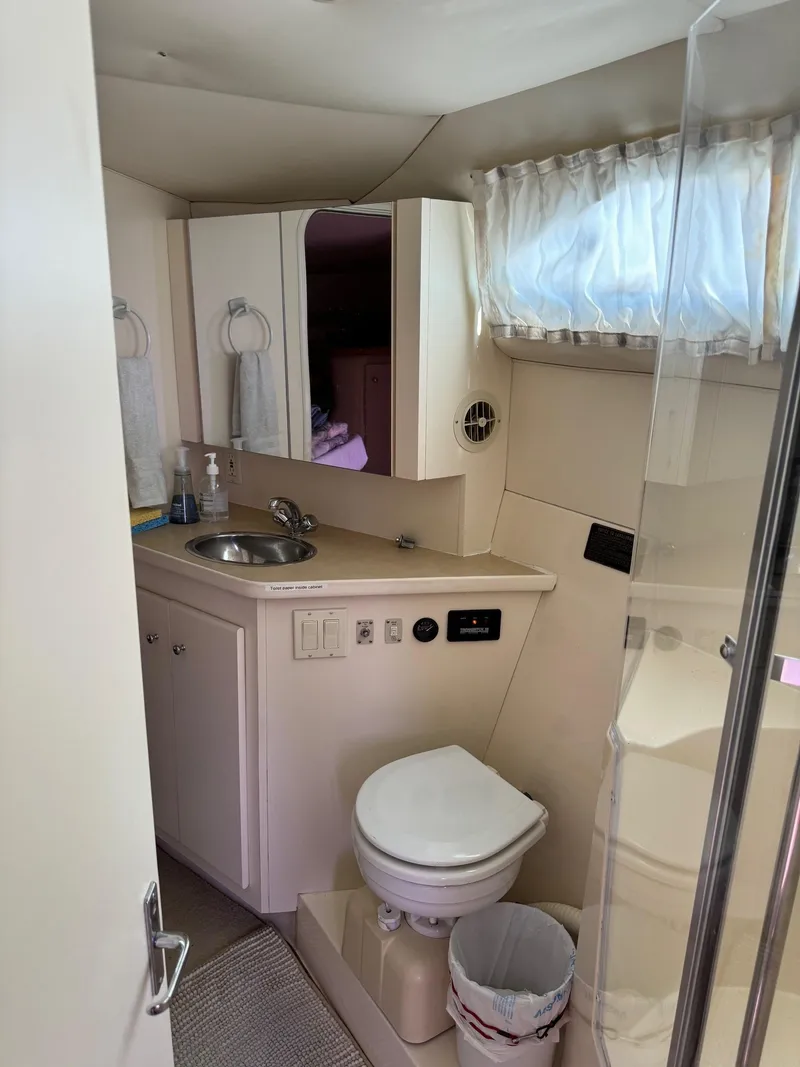 Slide: The Image of 1997 Carver 380 Santego SE yacht bathroom with sink, toilet, and shower. - 46