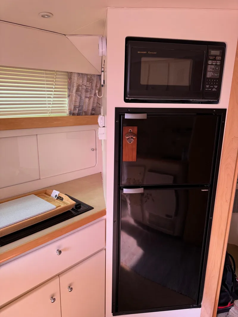 Slide: The Image of 1997 Carver 380 Santego SE kitchen with microwave and fridge. - 47