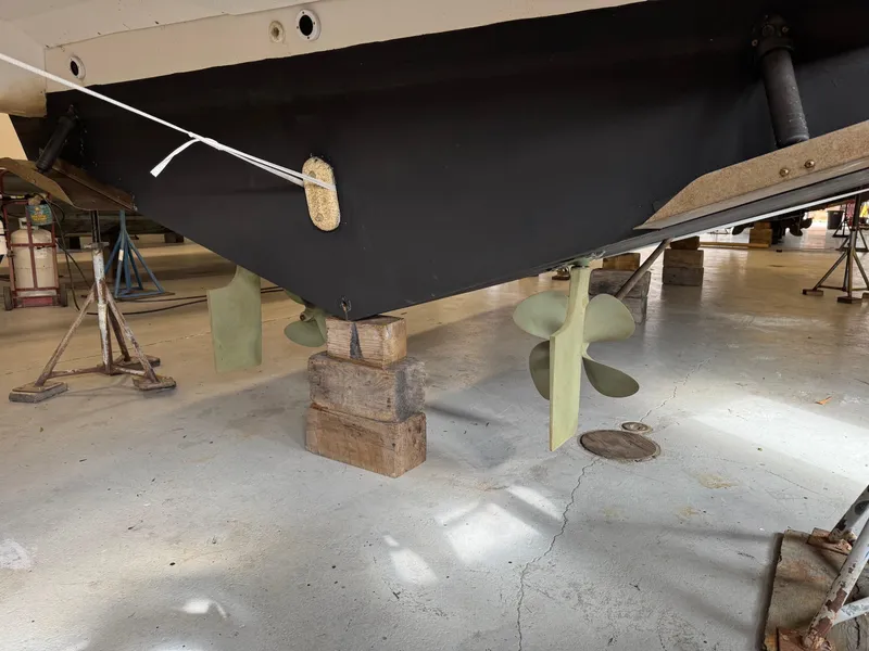 Slide: The Image of 1997 Carver 380 Santego SE boat hull and propellers in dry dock. - 48
