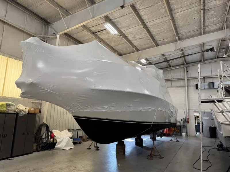 Slide: The Image of 1997 Carver 380 Santego SE boat covered in protective wrap inside a storage facility. - 50