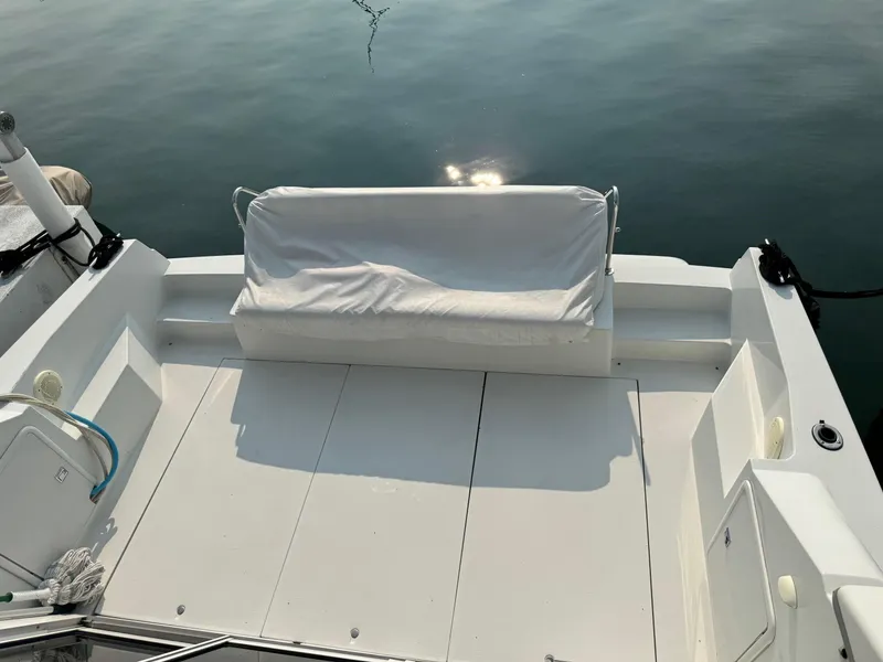 Slide: The Image of 1997 Carver 380 Santego SE boat deck with white seating, calm water reflection. - 6