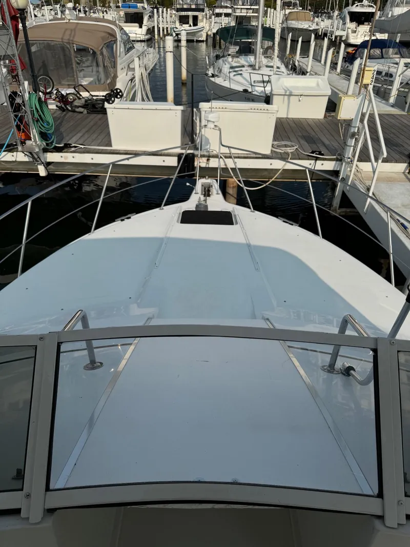 Slide: The Image of 1997 Carver 380 Santego SE yacht docked at marina, view from bow. - 8