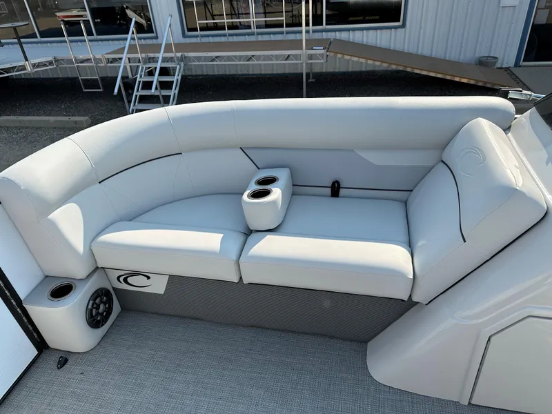 Slide: The Image of 2022 Crest Classic DLX 220 boat interior with white seating and cup holders. - 12