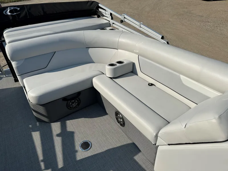 Slide: The Image of 2022 Crest Classic DLX 220 boat interior with plush seating and cup holders. - 14