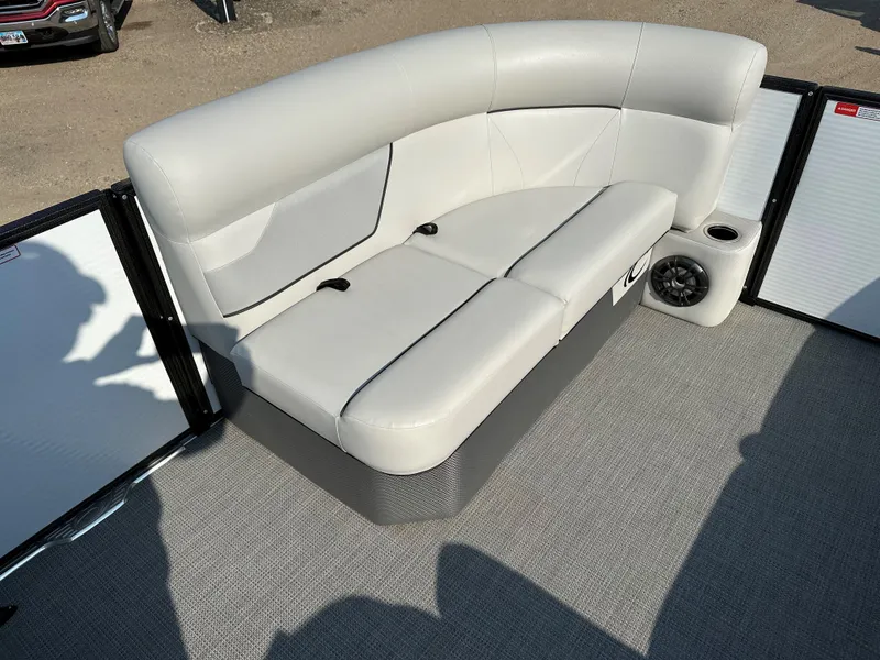 Slide: The Image of 2022 Crest Classic DLX 220 boat interior with plush seating and speaker. - 17