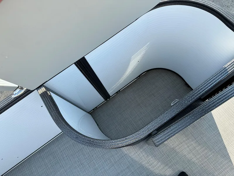 Slide: The Image of 2022 Crest Classic DLX 220 boat interior storage compartment with gray upholstery. - 21