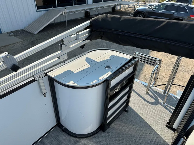 Slide: The Image of 2022 Crest Classic DLX 220 boat interior with storage compartments and railing. - 22