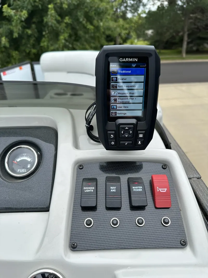 Slide: The Image of Garmin device on 2022 Crest Classic DLX 220 boat dashboard with control switches. - 24