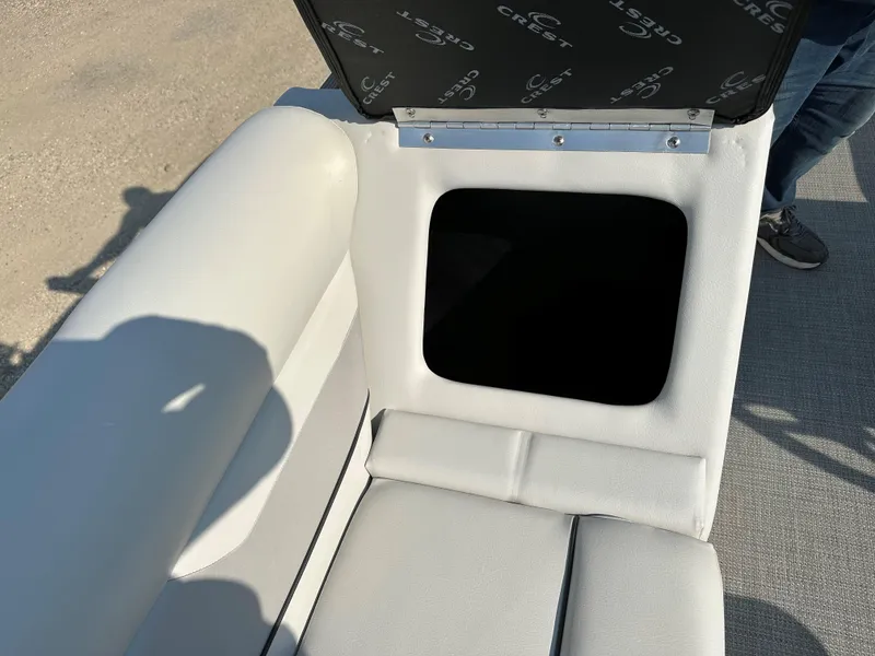 Slide: The Image of Crest Classic DLX 220 boat seat storage compartment, 2022 model, open lid view. - 7