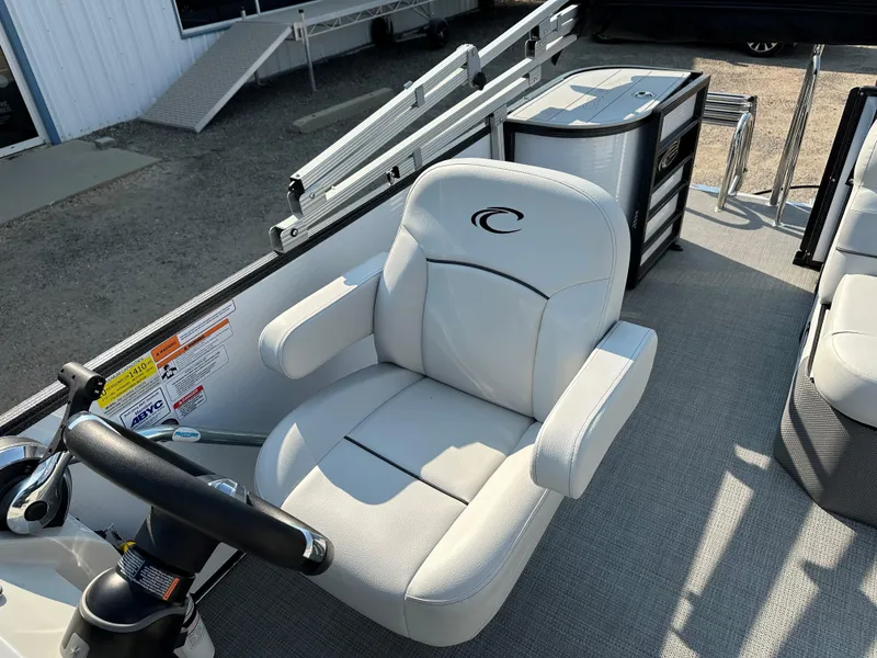 Slide: The Image of 2022 Crest Classic DLX 220 boat with comfortable captain's chair and steering wheel. - 9