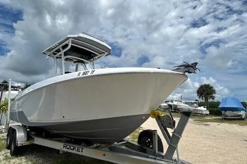 The Image of 2022 Wellcraft 222 Fisherman boat on trailer under cloudy sky. - 0