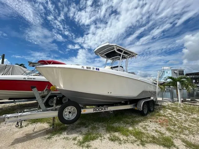 Slide: The Image of 2022 Wellcraft 222 Fisherman boat on trailer under a partly cloudy sky. - 1