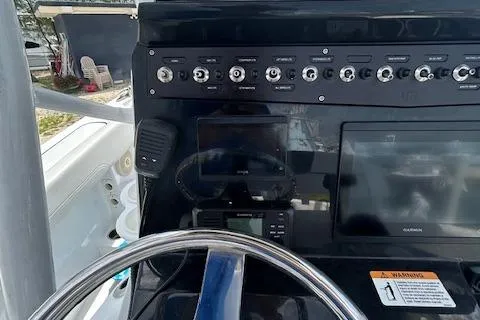 Slide: The Image of 2022 Wellcraft 222 Fisherman dashboard with steering wheel and control panel. - 10