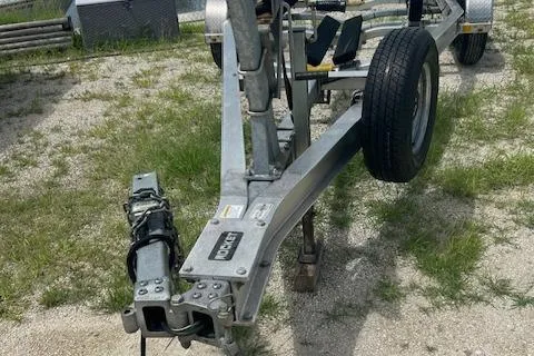 Slide: The Image of Boat trailer for 2022 Wellcraft 222 Fisherman on gravel and grass surface. - 12