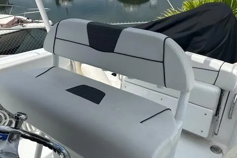 Slide: The Image of 2022 Wellcraft 222 Fisherman boat seat, gray upholstery, docked by water. - 8