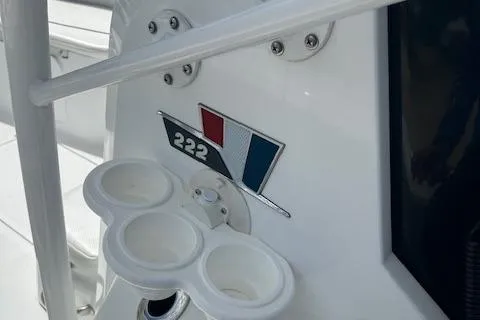 Slide: The Image of 2022 Wellcraft 222 Fisherman boat interior with cup holders and model emblem. - 9