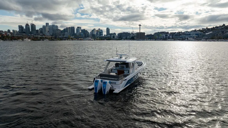 Slide: The Image of 2020 Tiara Sport 38 LS boat on water with city skyline in background. - 16