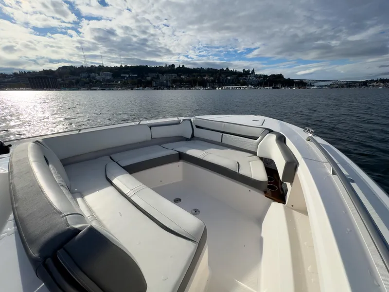 Slide: The Image of 2020 Tiara Sport 38 LS boat with spacious seating on a calm lake. - 18