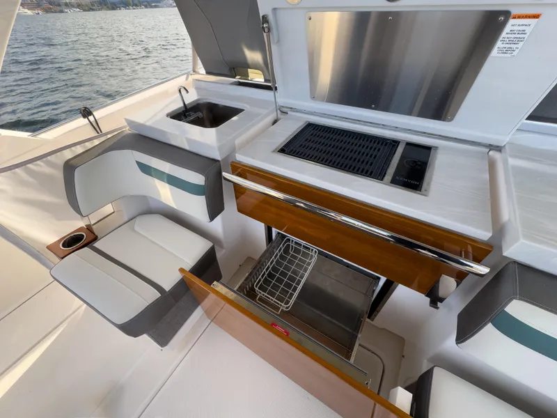 Slide: The Image of 2020 Tiara Sport 38 LS yacht interior with seating and kitchenette. - 25