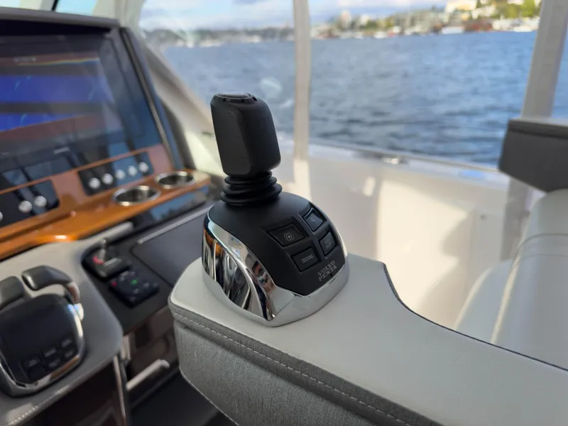 Slide: The Image of Tiara Sport 38 LS 2020 boat joystick control with scenic water view. - 31