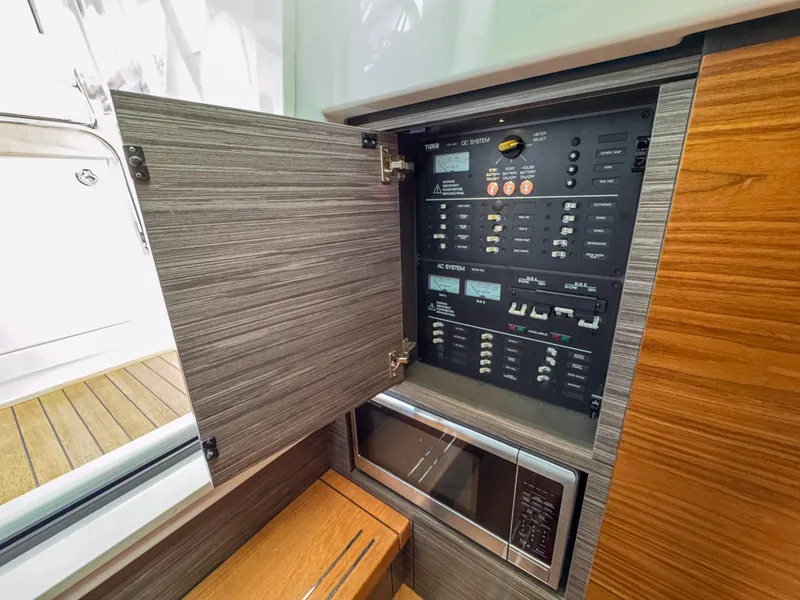 Slide: The Image of 2020 Tiara Sport 38 LS electrical panel and microwave in cabin interior. - 34