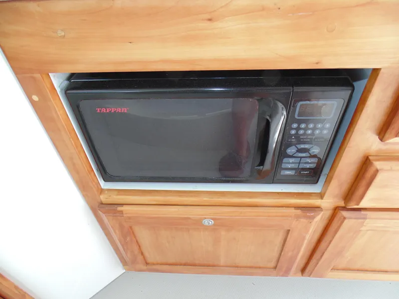 Slide: The Image of Built-in microwave in 2008 Back Cove 33 boat kitchen cabinetry. - 11