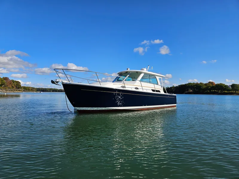 Slide: The Image of 2008 Back Cove 33 boat on calm water under a clear blue sky. - 16