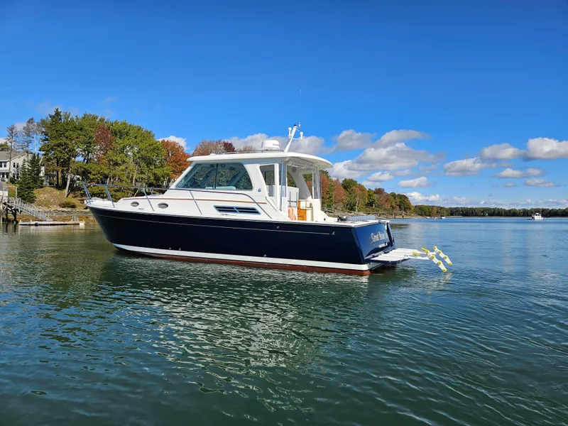 Slide: The Image of 2008 Back Cove 33 boat on calm water under clear blue sky. - 18