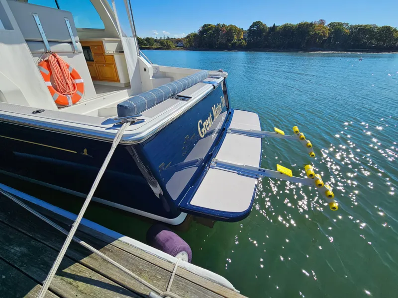 Slide: The Image of 2008 Back Cove 33 boat docked on a sunny day with a swim platform. - 22