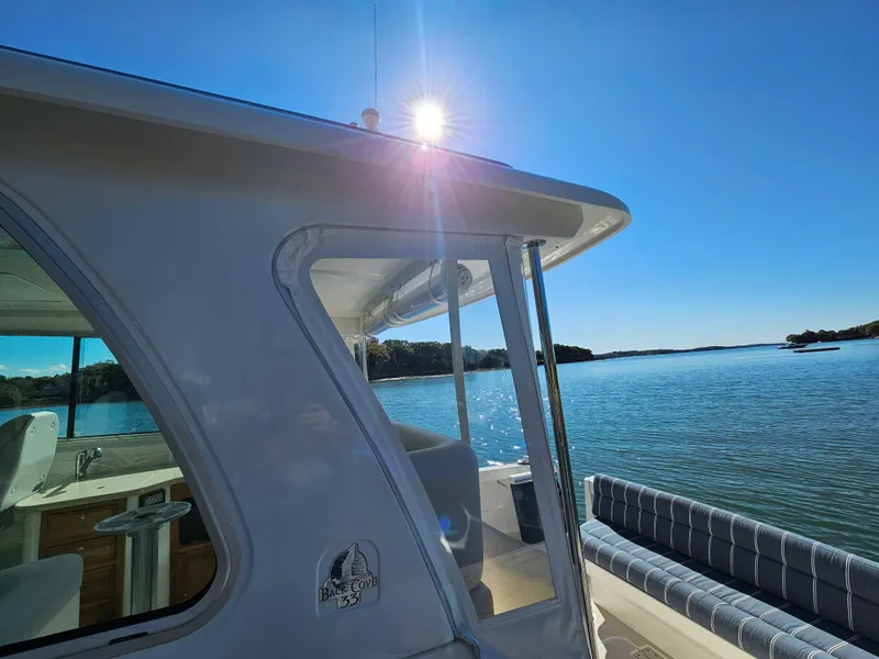 Slide: The Image of 2008 Back Cove 33 boat on serene water with clear blue sky. - 23