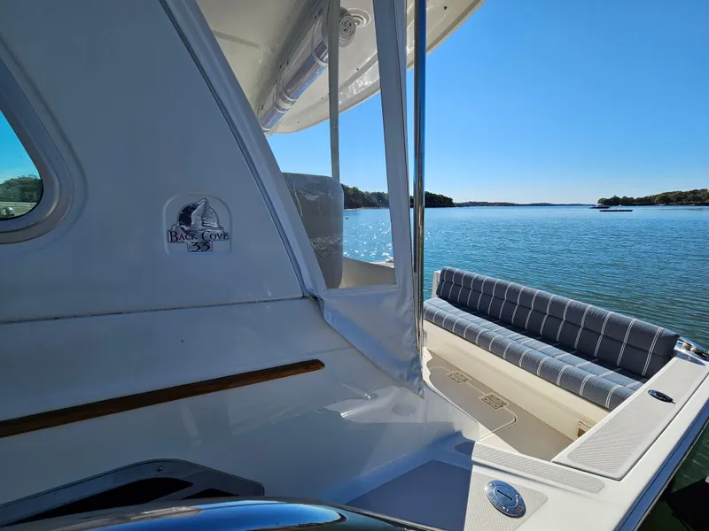 Slide: The Image of 2008 Back Cove 33 boat on serene water with clear blue sky. - 24