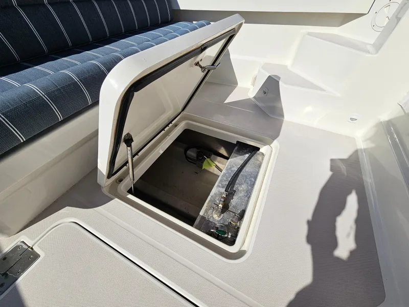 Slide: The Image of Open storage compartment on 2008 Back Cove 33 boat deck with cushioned seating. - 32