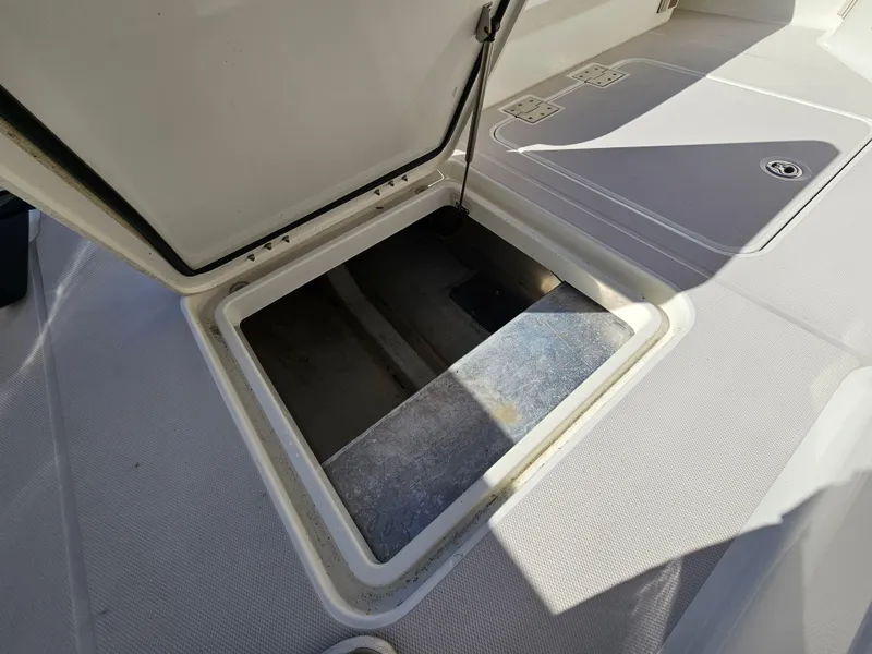 Slide: The Image of Open hatch on 2008 Back Cove 33 boat deck, revealing storage compartment. - 33