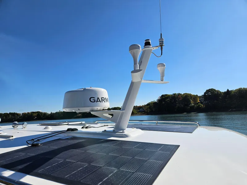 Slide: The Image of 2008 Back Cove 33 boat with Garmin radar and solar panels on a sunny day. - 43