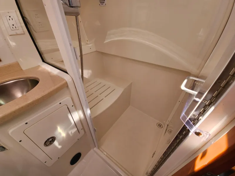 Slide: The Image of Shower area in 2008 Back Cove 33 boat, featuring a compact design with a built-in seat. - 46