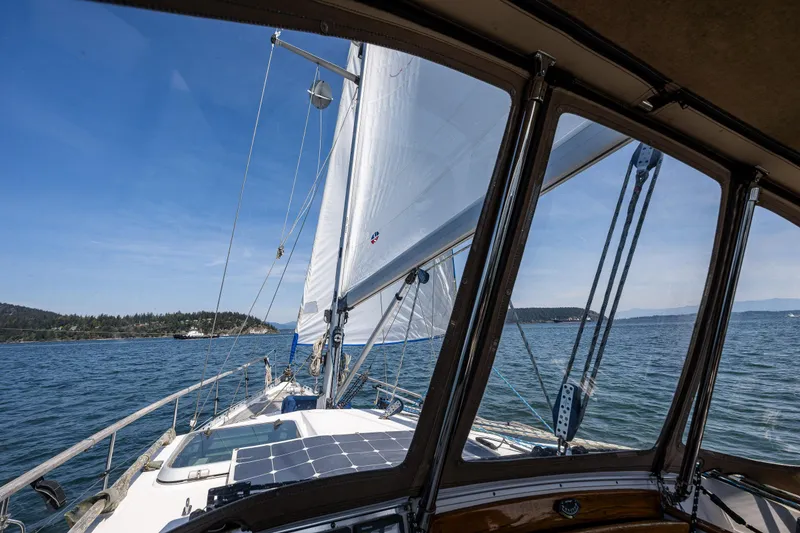 Slide: The Image of Nauticat 35 Pilot House sailboat on open water, view from cockpit, clear sky. - 15