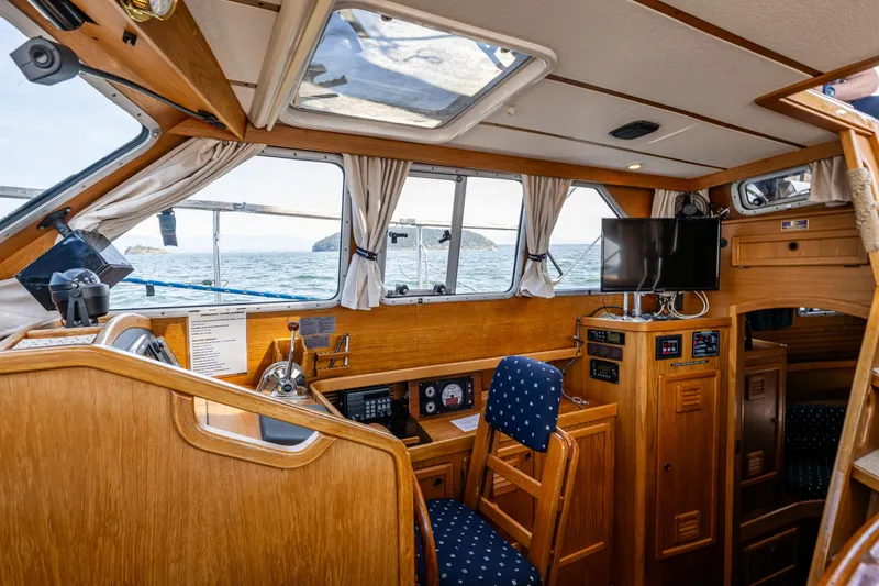 Slide: The Image of Cozy interior of 2000 Nauticat 35 Pilot House with wooden finish and ocean view. - 20