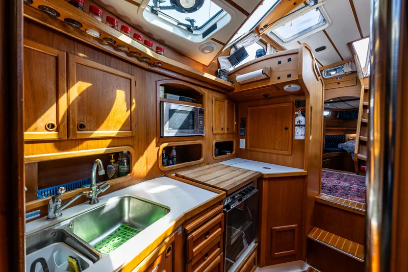 Slide: The Image of Cozy Nauticat 35 Pilot House kitchen with wooden cabinetry and modern appliances, year 2000 model. - 23