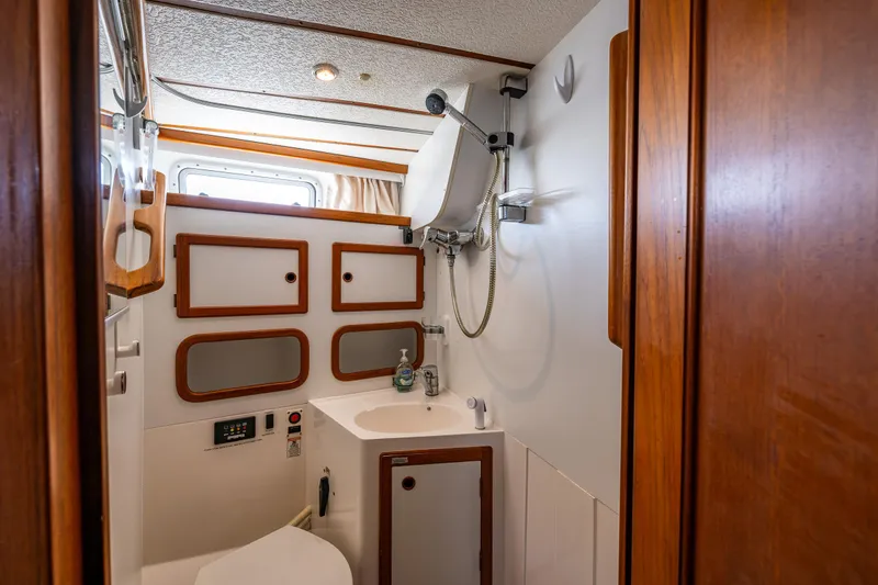 Slide: The Image of Nauticat 35 Pilot House 2000 bathroom with wooden accents and compact design. - 29