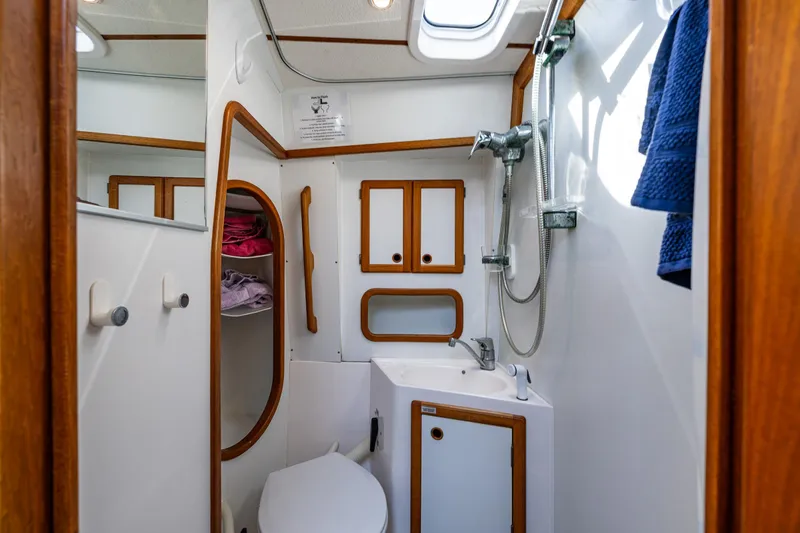 Slide: The Image of Bathroom interior of 2000 Nauticat 35 Pilot House with shower and wooden accents. - 32